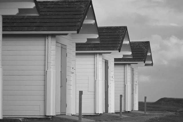 huts, shacks, nature, sheds, wood, wooden, timber, beach, coast, sea, seaside, coastal, monochrome, black and white, landscape. Three ways to frame a studio shed, and how to choose between them
